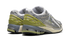 Close-up of New Balance 1906R sneaker details in Cactus Green